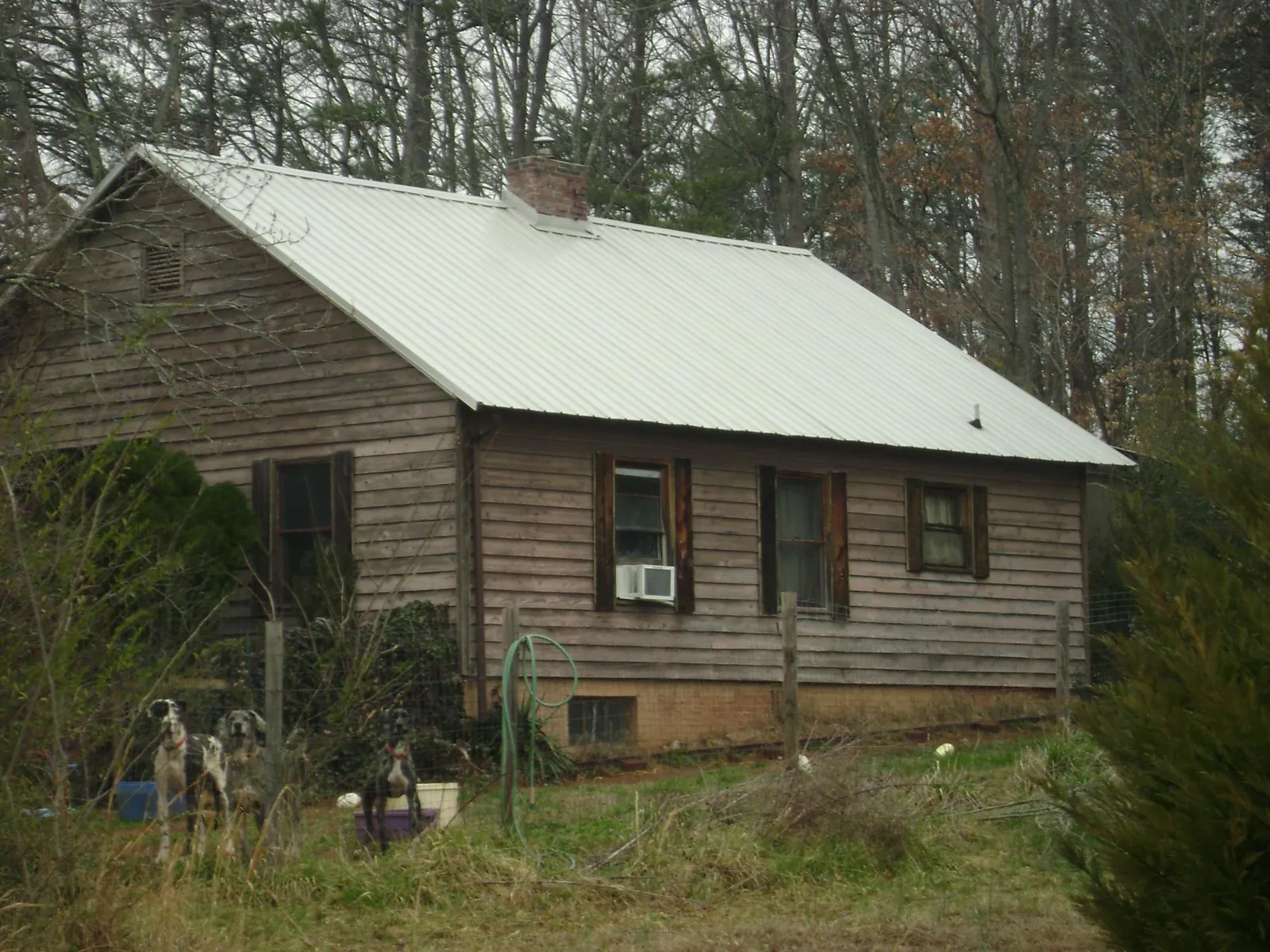 White metal roof on an old wood sided farmhouse, from a Metal Roof Installation job in Nicholasville